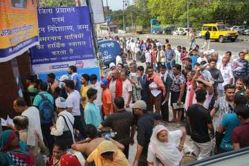 Pilgrims wait in a queue to get themselves registered for Amarnath Yatra, in Jammu on Sunday.