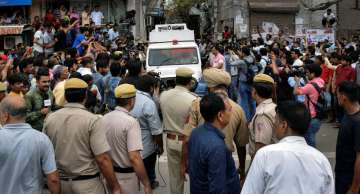 New Delhi: An ambulance carries away the bodies of the 11 members of a family- four men, three women and four girls- who were found hanging from an iron grill in a house, in Burari area on Sunday