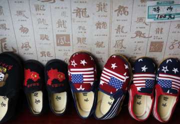 Chinese made children shoes carrying a Chinese map and U.S. flags are on display for a sale at a shop in Beijing. China announced it filled a World Trade Organization challenge Monday, to U.S. President Donald Trump's proposal for a tariff hike on $200 billion of Chinese goods, reacting swiftly amid deepening concern about the economic impact of their spiraling technology dispute.??
