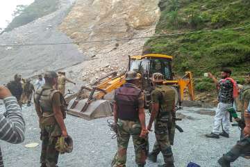 Army personnel at the site where a boulder rolled down and hit people bathing in a waterfall in Reasi district of Jammu and Kashmiron Sunday.