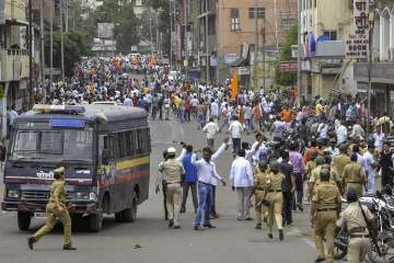 Police personnel clash with the Maratha Kranti Morcha protesters during their district bandh called for reservations in jobs and education, in Solapur, Maharashtra on Monday.