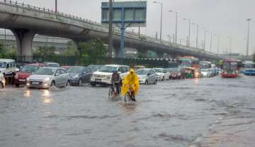 Noida: Vehicles ply at waterlogged Greater Noida Expressway during rains