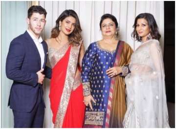 Nick Jonas poses with bae Priyanka Chopra and mother Madhu in this unseen photo from Akash- Shloka e