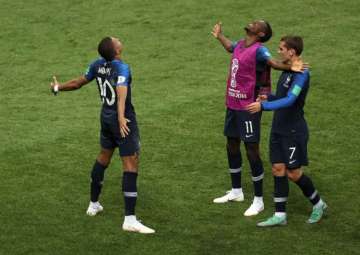 Kylian Mbappe of France celebrates with teammates after scoring his team's fourth goal