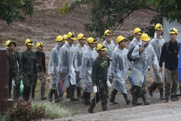 Rescuers walk toward the entrance to a cave complex where five were still trapped, in Mae Sai, Chiang Rai province, northern Thailand  on Tuesday.
