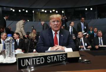 US President Donald Trump takes his seat as he attends the multilateral meeting of the North Atlantic Council on Wednesday 