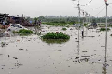 Vehicles stuck in the flood waters of Yamuna River at Usmanpur in east Delhi on Tuesday, July 31, 2018. The river is flowing above the danger mark flooding the areas along its banks. 