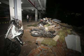 Debris on top of a motorcycles after an earthquake in Bali, Indonesia on Sunday 