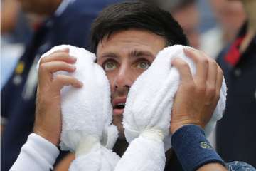 Novak Djokovic turns to 'survival mode' to win at steamy US Open