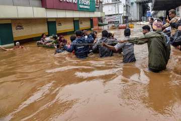Rescuers evacuate people from a flood-hit locality in Thiruvananthapuram