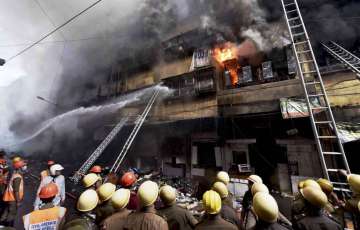 Firefighters try to douse a fire that broke out in a multi-storied wholesale Bagree market, at Burrabazar in Kolkata, Sunday, Sept 16