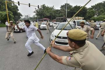 Policemen lathi-charge on members of Indian Youth Congress protesting during 'Bharat Bandh', against fuel price hike and depreciation of the rupee, in New Delhi.