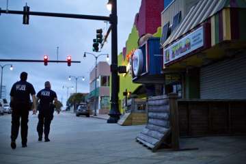 Police patrol the boardwalk in Myrtle Beach, S.C., as Hurricane Florence approaches the east coast.