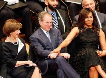 George Bush passes candy to Michelle Obama at John McCain’s memorial service