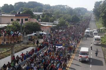 About a thousand migrants, including women and children, were still stranded on a border bridge hoping to enter Mexico legally via Guatemala.