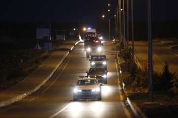 A convoy with US pastor sitting inside a car arrives for his trial in Izmir, Turkey