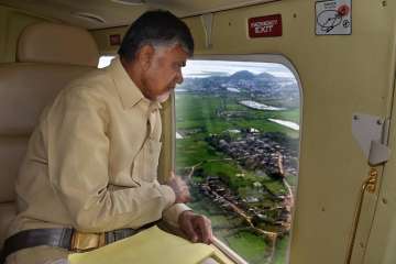 Andhra Pradesh Chief Minister N Chandrababu Naidu take a stock of areas affected by cyclone 'Titli' through an aerial survey, in Srikakulam on Friday.