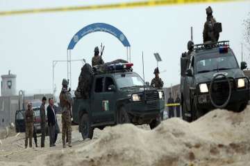 Security forces inspect the site of a suicide attack on prison employees' vehicle in Kabul, Afghanistan, Wednesday, Oct 31, 2018.