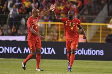 Belgium striker Romelu Lukaku (right) celebrates his second goal with teammate Vincent Kompany(left)