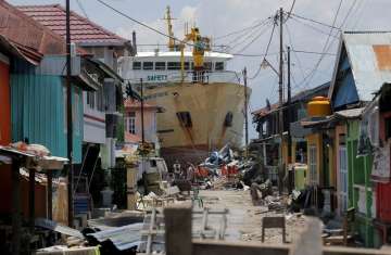 A ship rests near houses after it was swept ashore during Friday’s tsunami at a neighborhood in Donggala, Central Sulawesi, Indonesia.