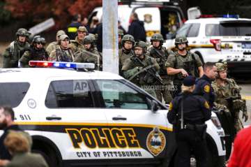 Law enforcement officers secure the scene where multiple people were shot, Saturday, Oct. 27, 2018, at the Tree of Life Congregation in Pittsburgh's Squirrel Hill neighborhood. (Alexandra Wimley/Pittsburgh Post-Gazette via AP)