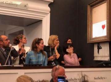 Banksy’s artwork destroys itself after being sold for over ?1mn at auction