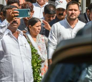  
Former Bihar chief minister Rabri Devi with her son Tejashwi Prasad Yadav coming out from Patiala House court in (IRCTC) tender scam case, in New Delhi on Saturday.
 