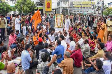 Thousands of BJP supporters marched to the secretariat in the Kerala capital of Thiruvananthapuram to protest the implementation of the Supreme Court judgment that ended the decade-old-ban of women inside the shrine of the Sabarimala Temple.
 
BJP activists, including a large number of women and children, marched to the administrative hub, Secretariat in Thiruvananthapuram, chanting mantras of Lord Ayyappa and holding the garlanded pictures of the deity.
 
The mammoth foot march, which started last week from Pandalam, was in protest against the Left government's decision to implement the top court order without considering sentiments of believers and Lord Ayyappa devotees.
 
The BJP has also alleged that the attempt to implement the judgment was a "conspiracy" to destroy the hillock shrine, where lakhs of people from the country and abroad visit during the three-month-long pilgrim season beginning mid-November.
 
An array of senior leaders of NDA including actor-turned MP, Suresh Gopi, Bharatiya Dharma Jana Sena chief Thushar Vellappally, were in the forefront of the march, led by BJP
state president P S Sreedharan Pillai.
 
Pillai said if the state government failed to resolve the issue at the earliest, the BJP-NDA's agitation would take a new turn.
 
"We will meet each villager in Kerala and chalk out a massive agitation plan to protect the Sabarimala Temple, its centuries-old traditions and the sentiments of Lord Ayyappa
devotees," he said.
 
Claiming that their first phase of the Sabarimala stir was a major 'milestone,' the BJP said if the CPI(M)-led LDF government does not find a solution in the next 24 hours, the party-led NDA would chalk out a 'massive' agitation plan to reach their goal.
 
The Sabarimala Temple, opening on October 17 evening, would be closed on October 22 after the five-day monthly pooja of Malayalam month of 'Thulam'.
 
Heavy security arrangements were put in place across the capital city, especially on the routes through which the BJP foot march passed.
 
Kerala has been witnessing a series of agitations by various devotee groups and Hindu outfits for some days demanding that the sanctity of the temple rituals beprotected.
 
Meanwhile, in another development, the Travancore Devaswom Board has convened a meeting of various stakeholders of the shrine including the Tantri (head priest) family, Pandalam royals and Ayyappa Seva Sangam on Tuesday.
 
The meeting, called to discuss the preparations of thethree-month-long annual Mandalam-Makaravilakku pilgrim season starting from November 17, was expected to discuss the recent Apex court order also. 
 
The mammoth foot march, which started last week from Pandalam, was in protest against the Left government's decision to implement the top court order without considering sentiments of believers and Lord Ayyappa devotees.