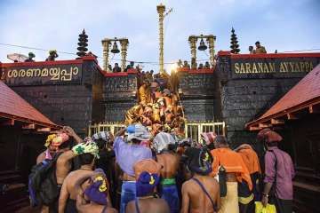 ?
?Devotees enter the Sabarimala temple as it opens amid tight security, in Sabarimala