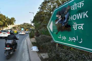 A Rajiv Chowk sign board defaced with black ink amid anti-Congress protest, in New Delhi
