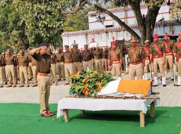 Police officials pay tribute to Police Inspector Subodh Kumar Singh, during a wreath-laying ceremony