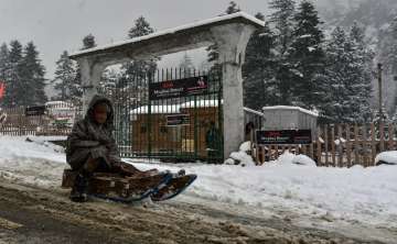 A child enjoy sledging on a road in Srinagar