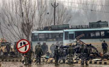 Security personnel carry out rescue and relief works at the site of suicide bomb attack at Lathepora Awantipora in Pulwama district of south Kashmir. 