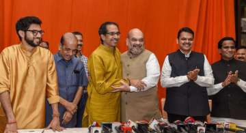 BJP President Amit Shah hugs Shiv Sena President Uddhav Thackeray after announcement of an alliance between Shiv Sena and BJP for Lok Sabha and Assembly polls, in Mumbai, Monday