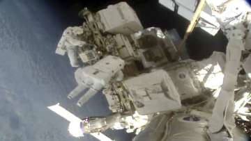 Spacewalking astronauts install better station batteries