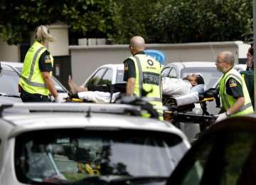 Ambulance staff take a man from outside a mosque in central Christchurch, New Zealand