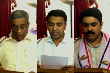 Sudin Dhavalikar, MGP (L), Pramod Sawant, BJP (C) and Vijai Sardesai, GFP (R) taking oath during a post-midnight ceremony at Raj Bhawan in Panaji