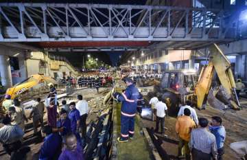 Mumbai: Rescue worker clear away debris of a collapsed foot overbridge in south Mumbai, Thursday, March 14, 2019. The bridge connected the bustling Chhatrapati Shivaji Maharaj Terminus railway station with the Azad Maidan Police Station.