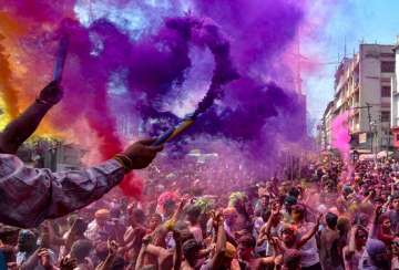 People play with colours on the occasion of Holi festival celebrations