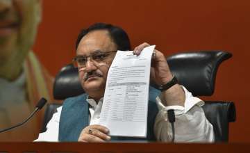 Union Minister and BJP leader JP Nadda shows the first list of candidates for the upcoming Lok Sabha elections, at party office in New Delhi