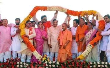 Uttar Pradesh Chief Minister Yogi Adityanath being garlanded at an election rally in support of Union Minister and BJP candidate Mahesh Sharma, ahead of the Lok Sabha elections