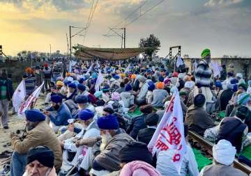 Farmers under the banner of Kisan Mazdoor Sangharsh Committee (KMSC) block a railway track during a protest to press for their various demands, at Devidaspura in Amritsar