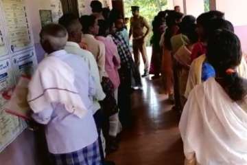 People standing at a polling booth in Kerala