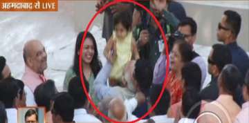 PM Narendra Modi embraces a child