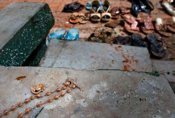 In this Monday, April 22, 2019, file photo, a rosary lies by the site of a suicide bombing at St. Sebastian Church in Negombo, Sri Lanka.