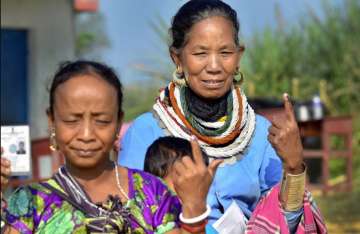 Agartala: Women of a tribal community show their inked marked finger after casting vote, during the third phase of the 2019 Lok Sabha elections, at polling station 