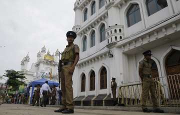 Sri Lankan police officers stand guard outside a Sufi Islamic mosque