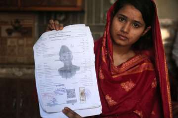 In this April 14, 2019 photo, Mahek Liaqat, who married a Chinese national, shows her marriage certificate in Gujranwala, Pakistan. Poor Pakistani Christian girls are being lured into marriages with Chinese men, whom they are told are Christian and wealthy only to end up trapped in China, married to men who are neither Christian nor well-to-do, and some are unable to return home.