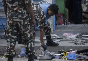 Nepalese army personnel examine the site of an explosion in Kathmandu.