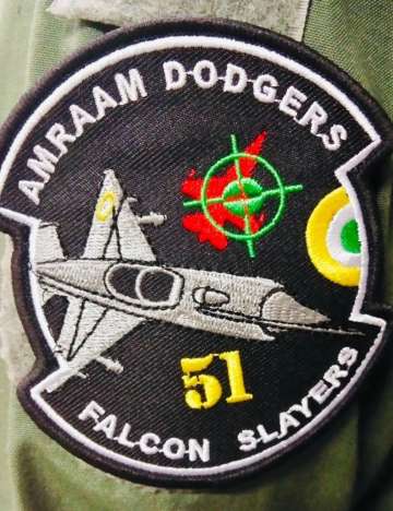 The said patch shows a MIG-21 Bison and a red-coloured F-16. 'AMRAAM Dodgers' is inscribed at the top and 'Falcon Slayers’ is at the bottom.
